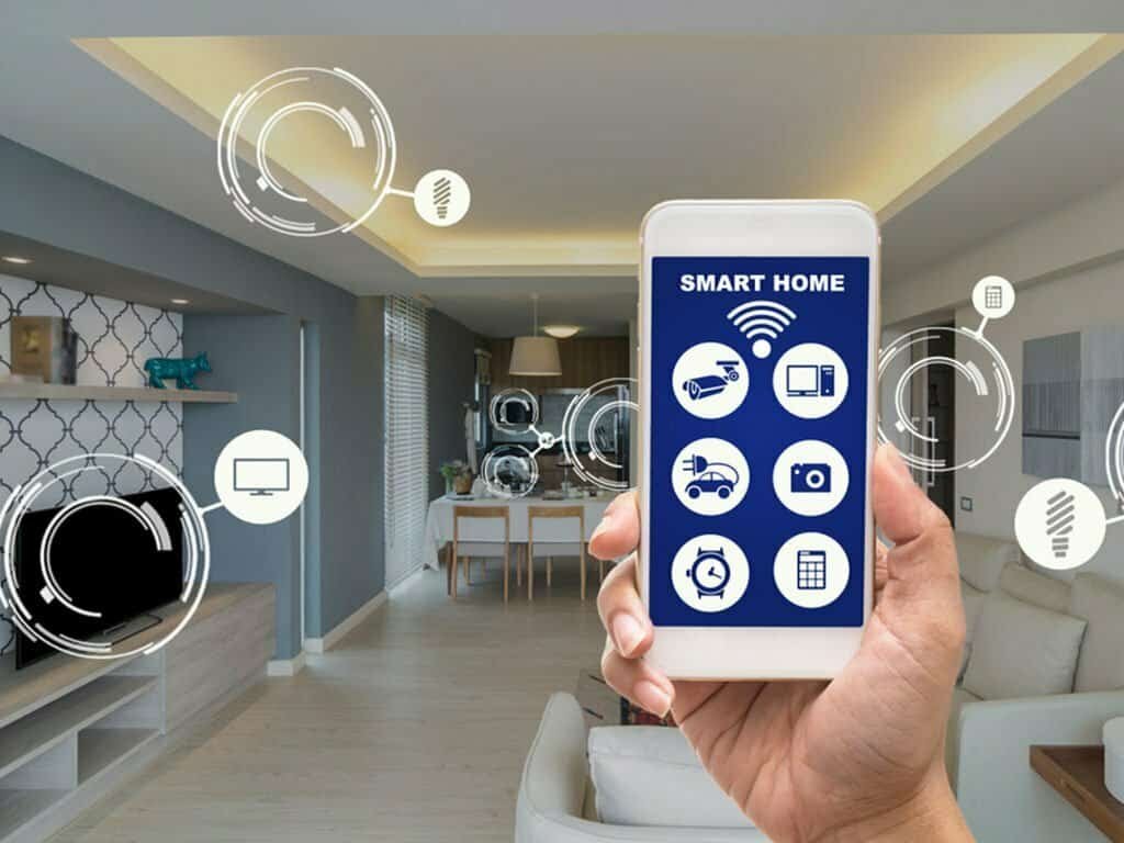 Hand holding "Smart Home" phone with icons over living room.