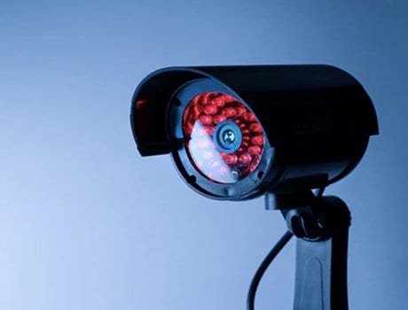 Black security camera with red infrared lights.