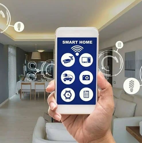 Hand holding smartphone with smart home app over living room.