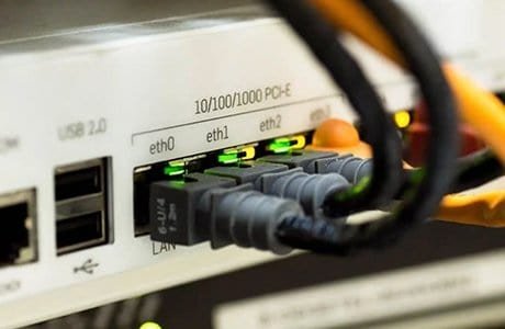 network switch with multiple Ethernet cables plugged in